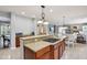 Kitchen with a cooking island, granite countertops, cherry cabinets and views to the living room, a culinary delight at 18725 Wychwood Pl, Noblesville, IN 46062