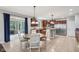 Bright kitchen with wood cabinets, granite countertops, a large stainless steel refrigerator, and a breakfast nook at 18725 Wychwood Pl, Noblesville, IN 46062