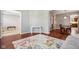 Open-concept living room with hardwood floors, natural light, and view into the kitchen at 18725 Wychwood Pl, Noblesville, IN 46062