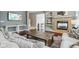 Cozy living room with a fireplace, built-in shelves, hardwood floors, and comfortable seating at 18725 Wychwood Pl, Noblesville, IN 46062
