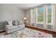 Bright living room with hardwood floors, comfortable seating, and large windows at 18725 Wychwood Pl, Noblesville, IN 46062