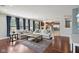 Open living room flowing into a modern kitchen, featuring hardwood floors and plenty of natural light at 18725 Wychwood Pl, Noblesville, IN 46062