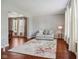 Cozy living room with hardwood floors, a floral rug, and ample natural light at 18725 Wychwood Pl, Noblesville, IN 46062