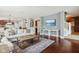Stylish living room with hardwood floors and an open layout leading to the kitchen and staircase at 18725 Wychwood Pl, Noblesville, IN 46062