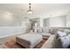 Open-concept living room with a sectional couch, pendant lights, and neutral decor at 18725 Wychwood Pl, Noblesville, IN 46062