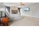 Main bedroom with a fireplace, ceiling fan, and large windows at 18725 Wychwood Pl, Noblesville, IN 46062
