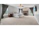 Main bedroom with a fireplace, carpet, ceiling fan and large windows at 18725 Wychwood Pl, Noblesville, IN 46062