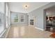 Bright sunroom with tile flooring, a fireplace, and views into the living room at 18725 Wychwood Pl, Noblesville, IN 46062