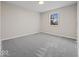 Simple bedroom with grey carpet and a window at 403 Wellington Blvd, Shelbyville, IN 46176