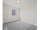 Spacious bedroom with grey carpeting and large window at 403 Wellington Blvd, Shelbyville, IN 46176