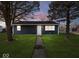 Newly built home with a dark blue exterior, well-manicured lawn, and walkway at 403 Wellington Blvd, Shelbyville, IN 46176