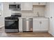 Modern kitchen features stainless steel appliances and white cabinetry at 403 Wellington Blvd, Shelbyville, IN 46176