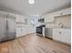 Modern kitchen with white cabinets and stainless steel appliances at 403 Wellington Blvd, Shelbyville, IN 46176