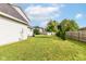 Spacious backyard features lush green grass, mature trees, and fencing for privacy at 493 Clearwater Blvd, Whiteland, IN 46184