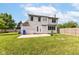 The backyard features a patio, green grass and a blue container for rain collection at 493 Clearwater Blvd, Whiteland, IN 46184