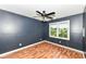 Cozy bedroom featuring a ceiling fan, stylish accent wall, and bright window at 493 Clearwater Blvd, Whiteland, IN 46184