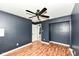 Relaxing bedroom features a ceiling fan, closet and attractive accent wall at 493 Clearwater Blvd, Whiteland, IN 46184