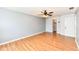 This bedroom features laminate floors, a ceiling fan, natural light, and closet and door access to other rooms at 493 Clearwater Blvd, Whiteland, IN 46184