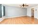 A view of a bright bedroom with laminate floors, a ceiling fan, and a view of the outside landscape at 493 Clearwater Blvd, Whiteland, IN 46184