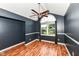 A view of a bedroom with laminate flooring, a ceiling fan, crown molding, and a bright window at 493 Clearwater Blvd, Whiteland, IN 46184