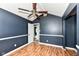 This bedroom offers an open door, ceiling fan, and a charming accent wall at 493 Clearwater Blvd, Whiteland, IN 46184