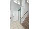 Bright entryway featuring tile flooring, a staircase, and a view to the upstairs at 493 Clearwater Blvd, Whiteland, IN 46184