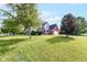 Spacious front yard with mature trees surrounding a two-story home with brick accents at 493 Clearwater Blvd, Whiteland, IN 46184