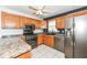 Efficient kitchen with stainless appliances, light wood cabinetry, and tiled floors at 493 Clearwater Blvd, Whiteland, IN 46184
