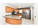Functional kitchen features stainless steel appliances, wood cabinets, and tile floors at 493 Clearwater Blvd, Whiteland, IN 46184