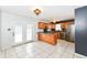 Open kitchen with stainless steel appliances, breakfast bar, tile flooring, and backyard access at 493 Clearwater Blvd, Whiteland, IN 46184