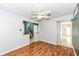 Bright living room with wood floors, ceiling fan, and an open view into the entryway and stairs at 493 Clearwater Blvd, Whiteland, IN 46184