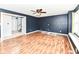An open living room with laminate floors and neutral wall colors is bright with natural light and features a ceiling fan at 493 Clearwater Blvd, Whiteland, IN 46184