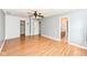 A spacious main bedroom with laminate flooring, a ceiling fan, a view to the ensuite, and access to a walk-in closet at 493 Clearwater Blvd, Whiteland, IN 46184