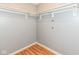A look inside a walk-in closet with a modern racking system and clean laminate floors at 493 Clearwater Blvd, Whiteland, IN 46184