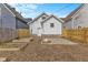 Backyard with a fire pit, wooden fence, raised garden beds, and a grassy area at 55 E Regent St, Indianapolis, IN 46225