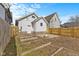Backyard view of a wooden fence, raised garden beds, and a fire pit area at 55 E Regent St, Indianapolis, IN 46225