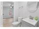 Bathroom featuring modern gray vanity, toilet and mirror at 55 E Regent St, Indianapolis, IN 46225