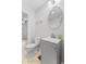 Bathroom featuring modern gray vanity, toilet and mirror at 55 E Regent St, Indianapolis, IN 46225