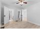A bright bedroom with wood flooring, white trim, and a ceiling fan at 55 E Regent St, Indianapolis, IN 46225