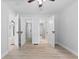 Bright bedroom with ceiling fan; provides multiple closets and bathroom access at 55 E Regent St, Indianapolis, IN 46225