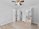 Spacious bedroom with ceiling fan; offers multiple closets and bathroom access at 55 E Regent St, Indianapolis, IN 46225