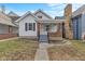 Charming home with a walkway leading to a covered porch and brick accents at 55 E Regent St, Indianapolis, IN 46225