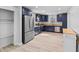 Well-lit kitchen featuring stainless steel appliances and blue cabinets at 55 E Regent St, Indianapolis, IN 46225