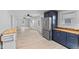 Bright, open-concept living room adjacent to kitchen; updated with modern flooring, neutral paint at 55 E Regent St, Indianapolis, IN 46225