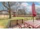 Deck with red table set and backyard view at 6149 Winnpeny Ln, Indianapolis, IN 46220