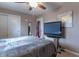 Bedroom featuring a large TV, ceiling fan and ample closet space at 6149 Winnpeny Ln, Indianapolis, IN 46220