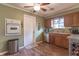 Galley kitchen with wood cabinets, built-in oven, and hardwood floors at 6149 Winnpeny Ln, Indianapolis, IN 46220