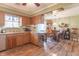 Kitchen with wood cabinets, hardwood floors, and adjoining dining area at 6149 Winnpeny Ln, Indianapolis, IN 46220