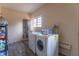 Laundry room with washer, dryer, and extra storage at 6149 Winnpeny Ln, Indianapolis, IN 46220