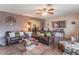 Living room featuring hardwood floors, two leather sofas, and a ceiling fan at 6149 Winnpeny Ln, Indianapolis, IN 46220